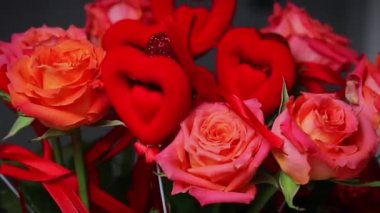 ed roses with red hearts, a bouquet of roses with hearts for Valentine's Day, a bouquet of roses for March 8
