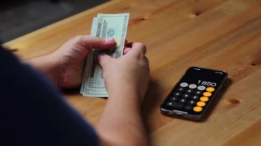  coins in hand, person with calculator and money, accounting coins