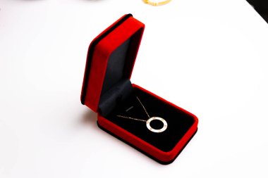 gold ring with red bow on white background