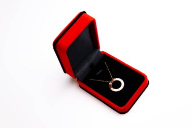 red wedding ring with a gold bow on a white background