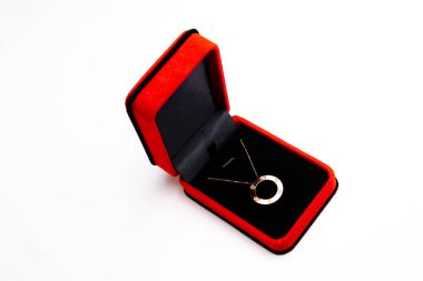 red heart with a ring on a white background