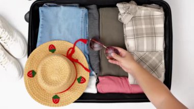 Yaz tatili konsepti. Farklı şeyler ve aksesuarlarla dolu bavul.