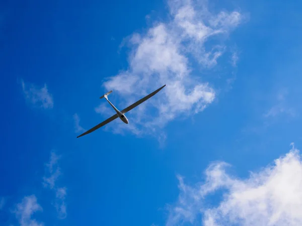 stock image A glider is a fixed-wing aircraft that is supported in flight by the dynamic reaction of the air against its lifting surfaces, and whose free flight does not depend on an engine.