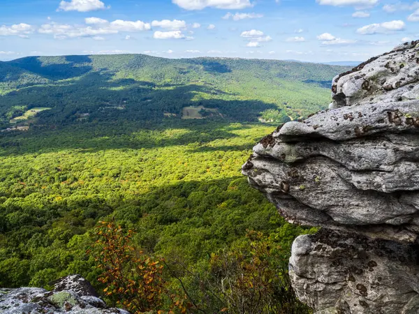 The beautiful wilderness with wooded mountains with rocks in the foreground as seen from Big Schloss via Wolf Gap Trail on the border between West Virginia and Virginia.