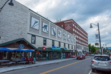 Famous Grand Adirondack Hotel  on Main Street in downtown Lake Placid, Upstate New York, capturing the charm and vibrancy of this picturesque town. clipart