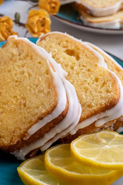 Close up view of lemon cake on plate with lemons on side. Delicious fresh homemade dessert . High quality photo