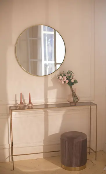 Empty modern, minimal beige dressing table. stylish modern dressing table for beauty make up cosmetic skincare products display with round mirror. Glamour. cream wall bedroom