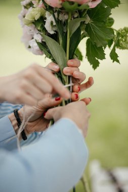 Düğün buketini hazırlayan kadın ellerini kapat.