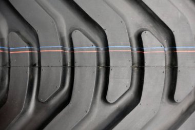 Details of tractor tire. Detail of large wheel. Heavy black wheel. Tread tire of a tractor. Harvester close-up