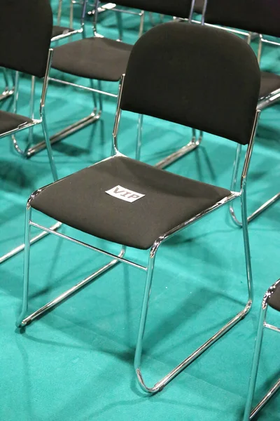Black metal chair for a vip v.i.p person in empty auditorium