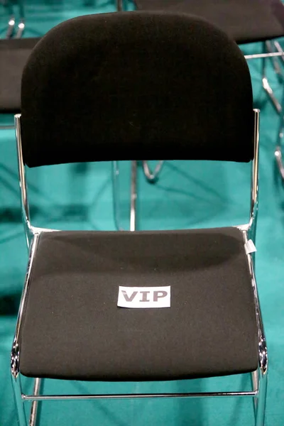Black metal chair for a vip v.i.p person in empty auditorium