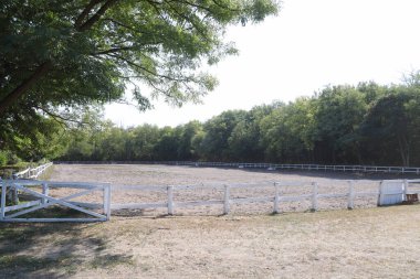 Beautiful photo of empty equestrian field for horse training. Equestrian background