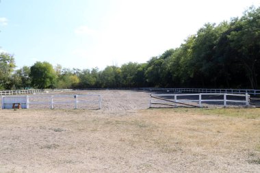 Beautiful photo of empty equestrian field for horse training. Equestrian background