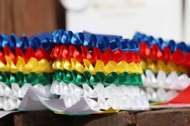 Pile of horse sport trophies rosettes at equestrian event at summertime outdoors