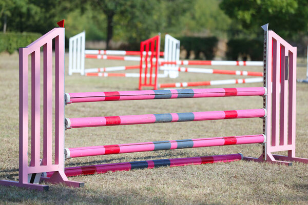Show jumping poles obstacles, barriers, waiting for riders on show jumping training. Horse obstacle course outdoors summertime