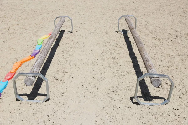 stock image Show jumping poles obstacles, barriers, waiting for riders on show jumping training. Horse obstacle course outdoors summertime. Poles in the sand at equestrian center outdoors