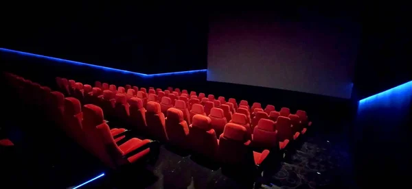 Empty cinema hall with red seats. Interior of modern movie theatre. Cinema movie theater concept background. Red cinema seats .