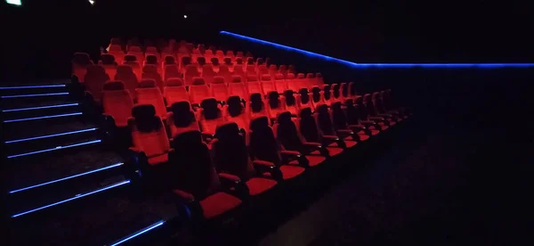 Empty cinema hall with red seats. Interior of modern movie theatre. Cinema movie theater concept background. Red cinema seats .