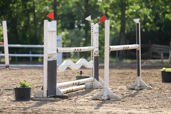 stock image Show jumping poles obstacles, barriers, waiting for riders on show jumping training. Horse obstacle course outdoors summertime. Poles in the sand for equestrian event