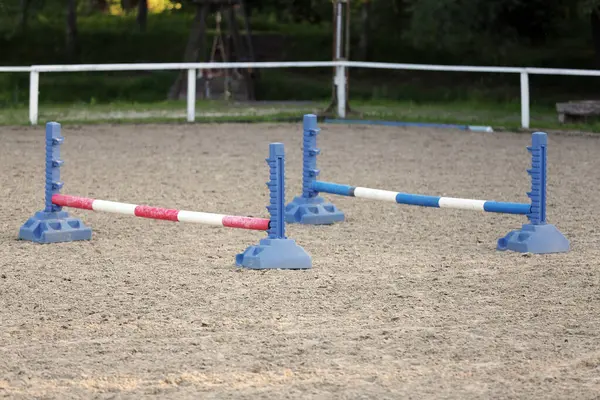 stock image Show jumping poles obstacles, barriers, waiting for riders on show jumping training. Horse obstacle course outdoors summertime. Poles in the sand for equestrian event