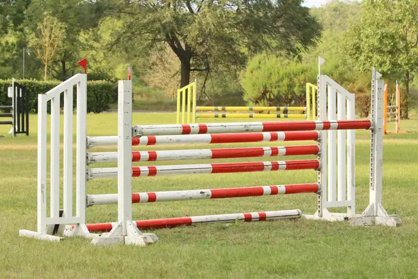 stock image Show jumping poles obstacles, barriers, waiting for riders on show jumping training. Horse obstacle course outdoors summertime. Poles in the sand for equestrian event