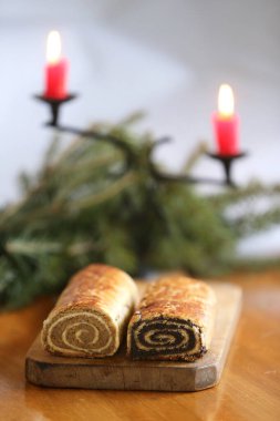 Homemade walnut and poppy seed rolls aka beigli in Hungary. Traditional hungarian christmas or easter cake bejgli at christmastime.Freshly baked sweet pies filled strudel on wooden board clipart