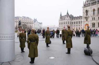 BUDAPEST, HUNGARY - January 18, 2025: Evening Hungarian National Flag Ceremony in front of the Parliament building with members of the Crown Guard. Budapest, Hungary, Kossuth Square clipart