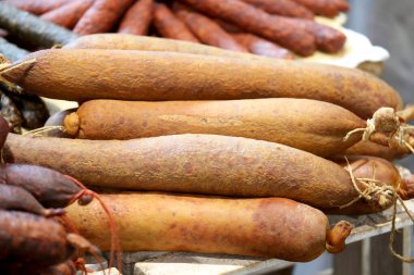 Geleneksel Macar ev yapımı özel yiyecekler, salam sosisi vs. yakın çekim kompozisyonu. Satılık çiftçi pazarında. Piyasada satılan ev yapımı lezzetli ürünler yığını