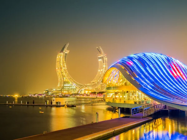 stock image New modern buildings on the beachfront lit up at night in Lusail, Doha, Qatar