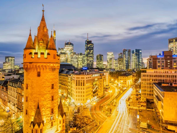 stock image Eschenheim Tower, old and new Frankfurt city buildings lit up at night