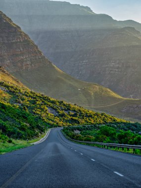 Winding road through towering mountains from Worcester to cape town, South Africa clipart