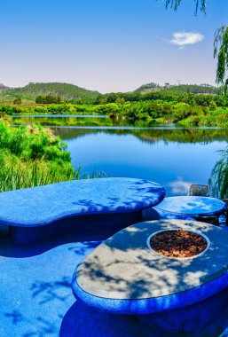 Concrete outdoor furniture on the bank of the Palmiet River, Elgin Valley, South Africa clipart