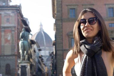 Portrait of woman smiling with sunglasses unfocused background at Florence, Italy. 50mm lens. High quality photo