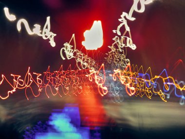 Bulanık ve dağınık gece lambaları bir arabanın içinden görülebiliyor ve uzun süre iz bırakabiliyor.