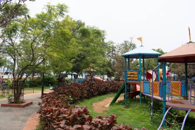 lake view resort, ranchi, jharkhand, india - july 14, 2024 : decorated garden using nature with children's recreation facility inside the premises clipart