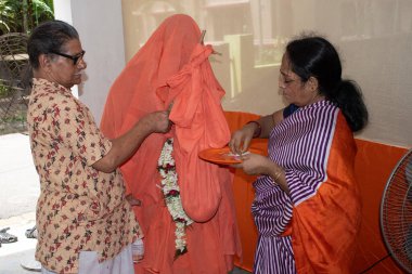 kolkata, west bengal, india - august 09, 2024 : elders of hindu family performing sacred thread rituals clipart