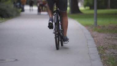 Parkta bisiklete binen biri. Yavaş çekim. 