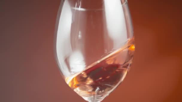 Close Rose Wine Waving Wineglass Slow Motion — Stock Video