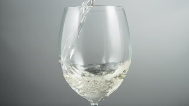 Close Pouring White Wine Wineglass Grey Background Slow Motion — 图库视频影像