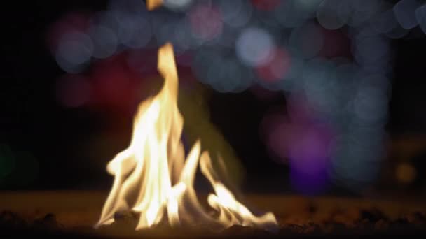 Fire Burning Fire Pit Holiday Lights Background Slow Motion — Stock Video