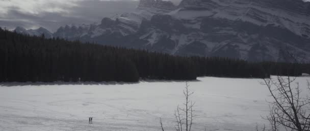 Dva Lidé Zimě Přecházejí Zamrzlé Jezero Kanadských Skalistých Horách Zpomalený Stock Záběr