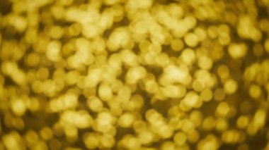 Işıldayan sarı parıltının soyut bokeh arkaplanı. 