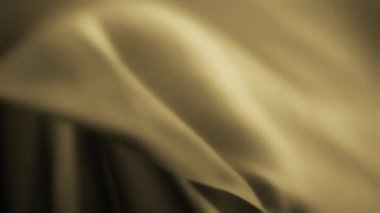 Rüzgarda sallanan sarı ipeksi tekstilin soyut arka planı. Yavaş çekim. 