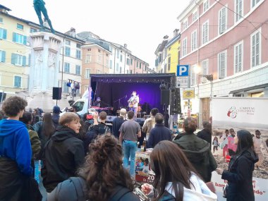 Parma, Italy - October 06, 2024: Street festival Concert in Parma City, Italy. People enjoying moment.  Old ancient building background. Historical Parma city. clipart