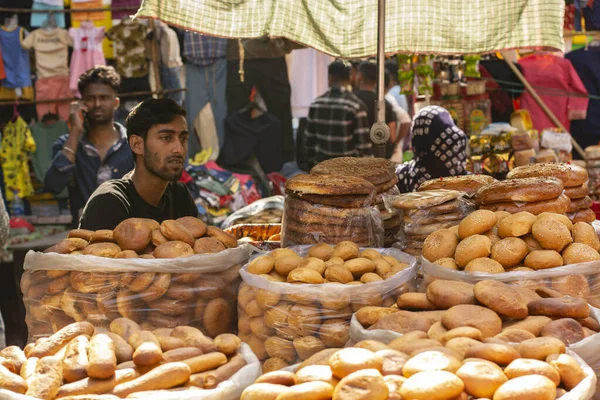 stock image 6th April, 2023, Kolkata, West Bengal, India: A man of muslim religion selling a type of bread at the Zakaria street at the time of Ramadan.