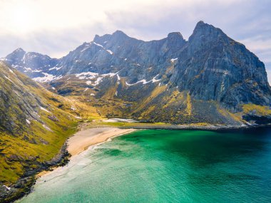 Aerial photographs of Kvalvika Beach in Lofoten, Norway, during spring on a clear day with clouds