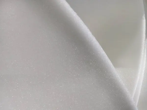 white thin foam sponge texture. folds of soft textured materialwhite thin foam sponge texture. folds of soft textured material