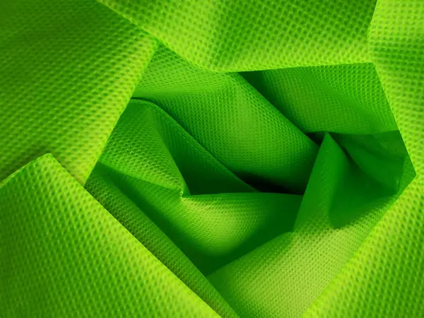 Stock image light green non-woven fabric texture. polypropyline fabric detail with wrinkles and roughness