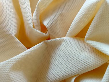 krem rengi, dokumasız kumaş dokusu. Kırışıklık ve pürüzlü polipropilen kumaş detayı