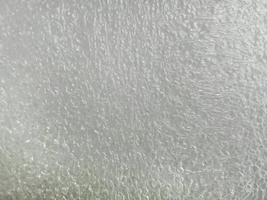 Kaba ve gözenekli, beyaz sünger köpük yüzey arkaplanı. Parlak sentetik malzeme